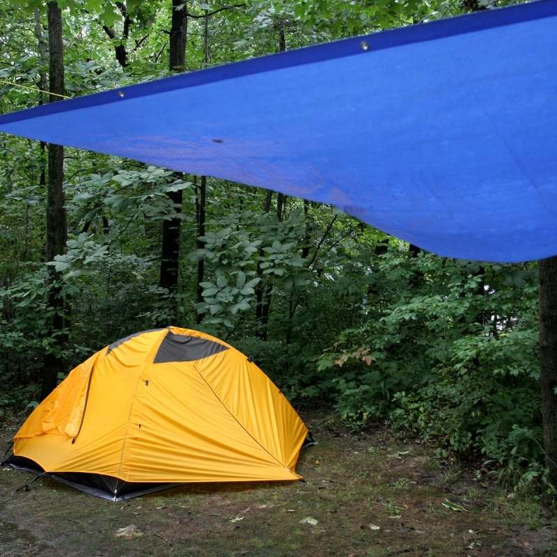 tarp or footprint being used as a shelter when camping