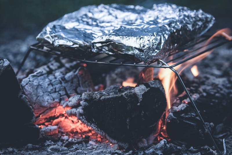 foil packet meal cooking over a campfire